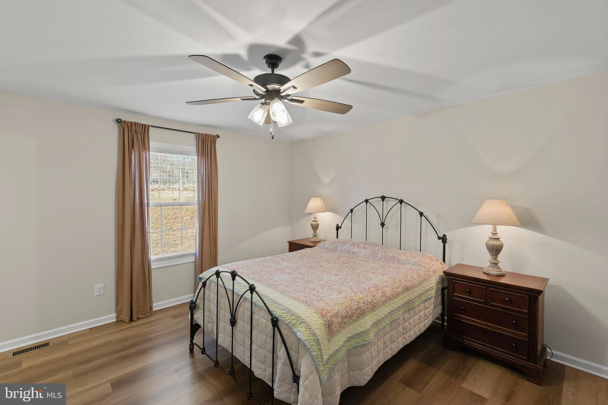 4009 Ridge Road Quicksburg, VA 22847 - Photo 14 of 41 a bedroom with a bed and a chandelier
