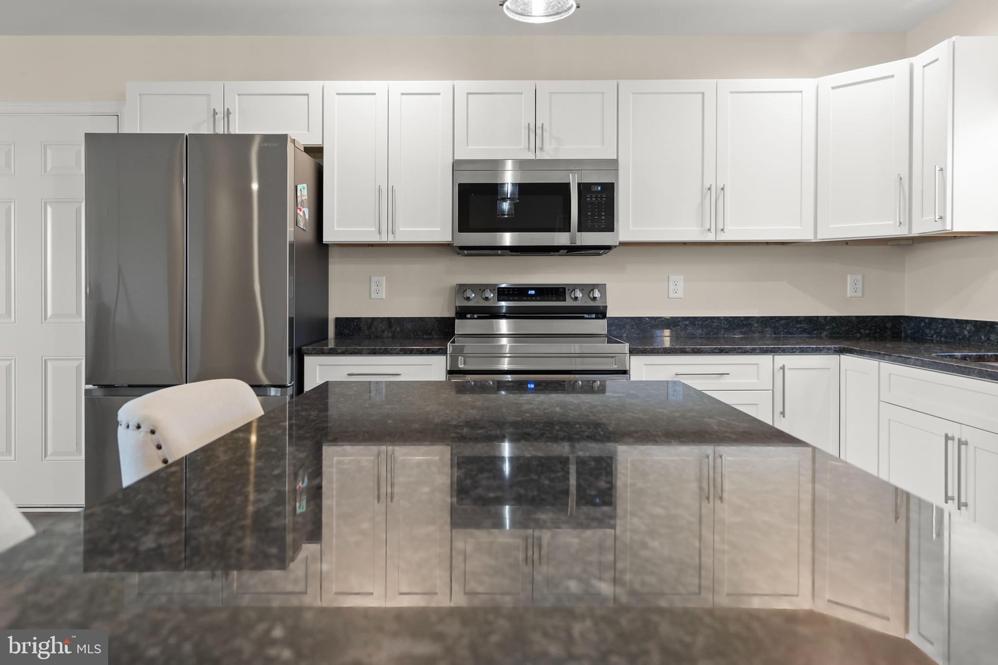 4009 Ridge Road Quicksburg, VA 22847 - Photo 5 of 41 a kitchen with stainless steel appliances granite countertop a stove a microwave and a refrigerator