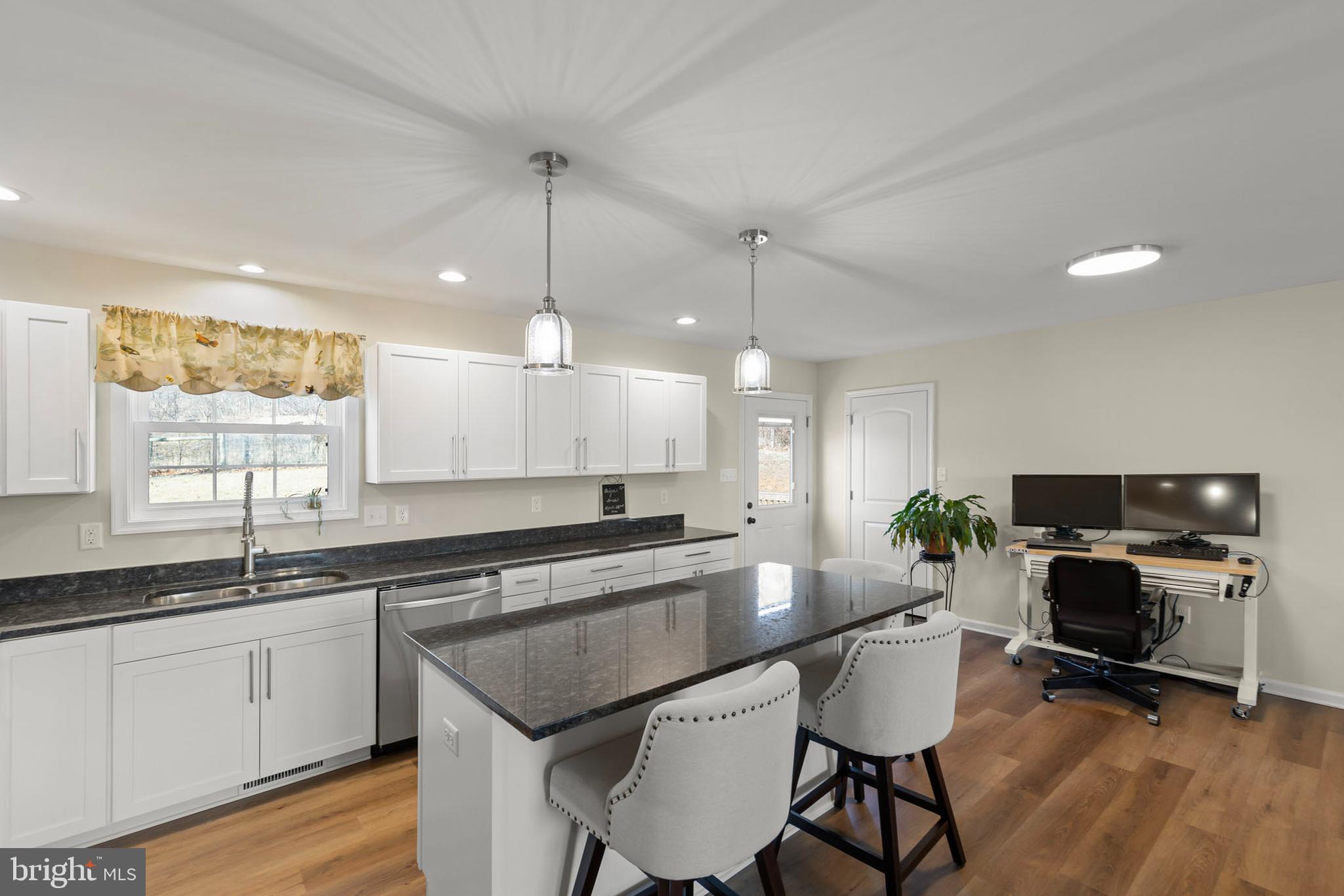 4009 Ridge Road Quicksburg, VA 22847 - Photo 6 of 41 a kitchen with a sink a center island cabinets and stainless steel appliances