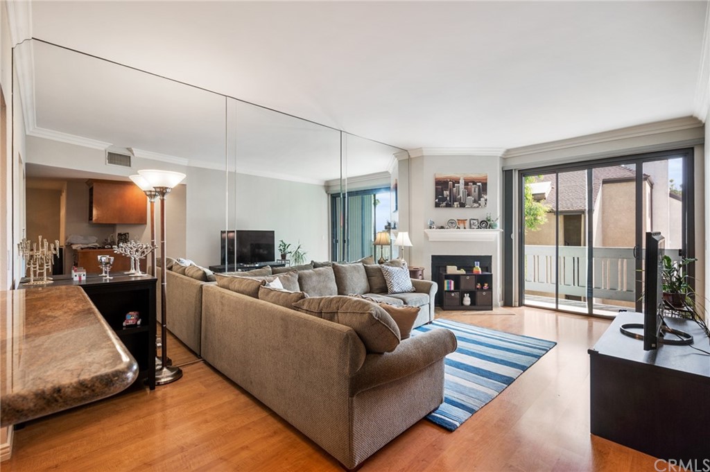 a living room with furniture large window and a fireplace