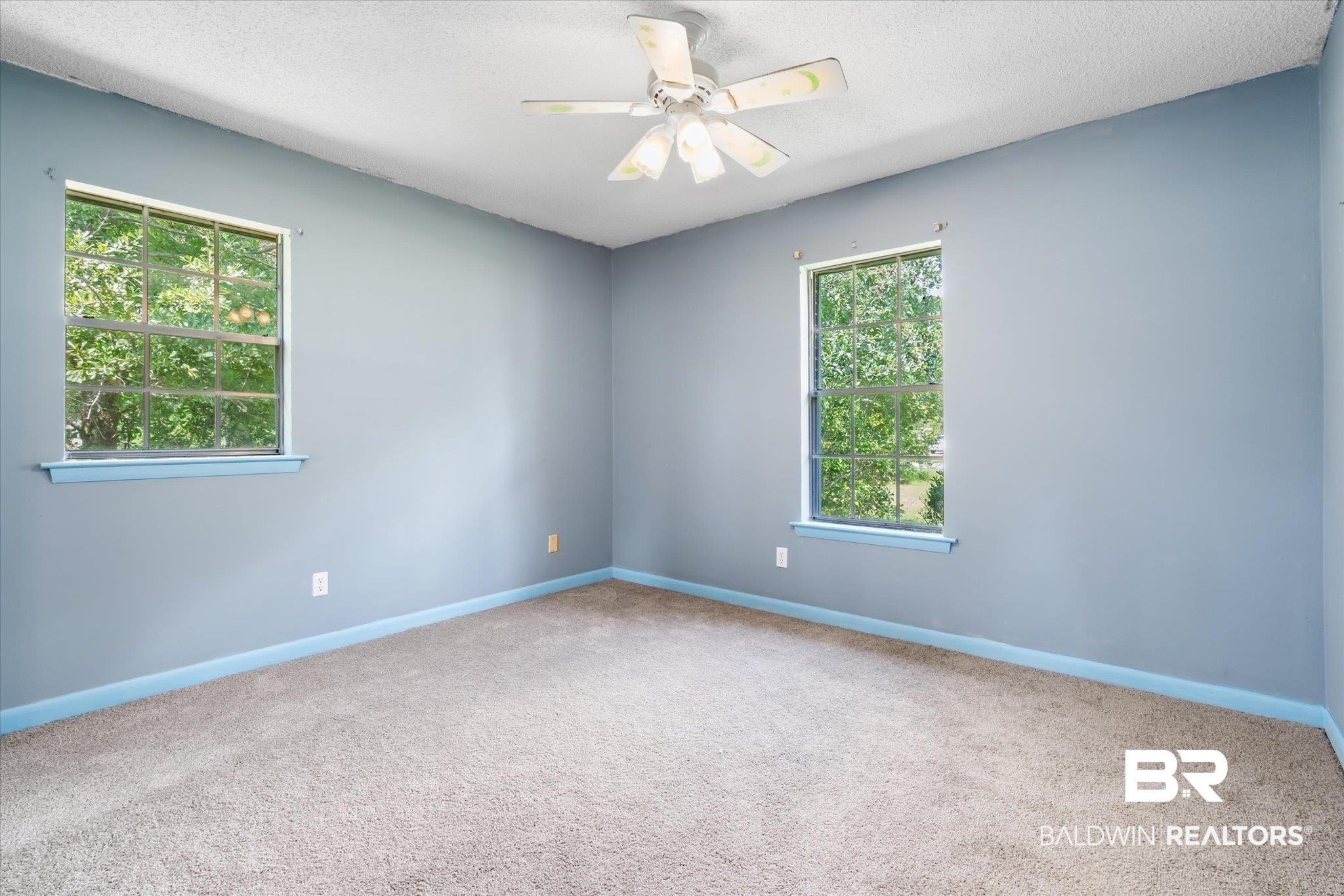 16808 Witt Road Bon Secour, AL 36511 - Photo 7 of 31 Carpeted empty room featuring a textured ceiling, ceiling fan, and plenty of natural light