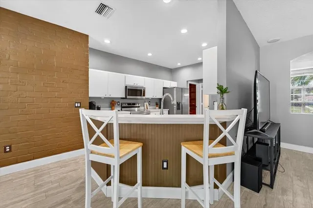 a kitchen with cabinets appliances and a sink