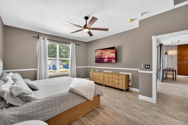 a bathroom with a double vanity sink a mirror a shower and a bathtub