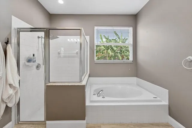 a view of walk in closet with clothes