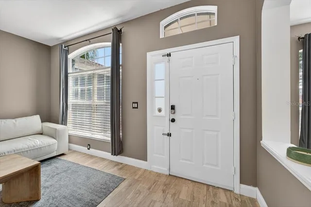 a view of a livingroom with furniture window and wooden floor