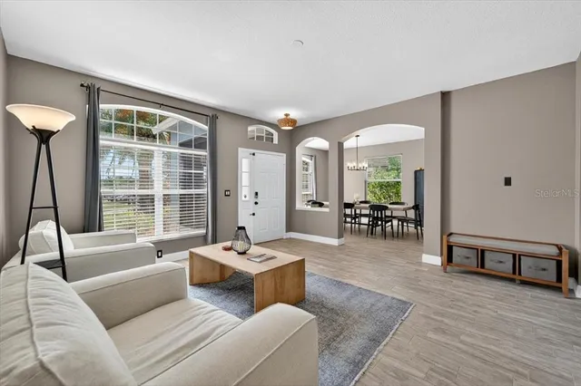 a living room with furniture and a wooden floor