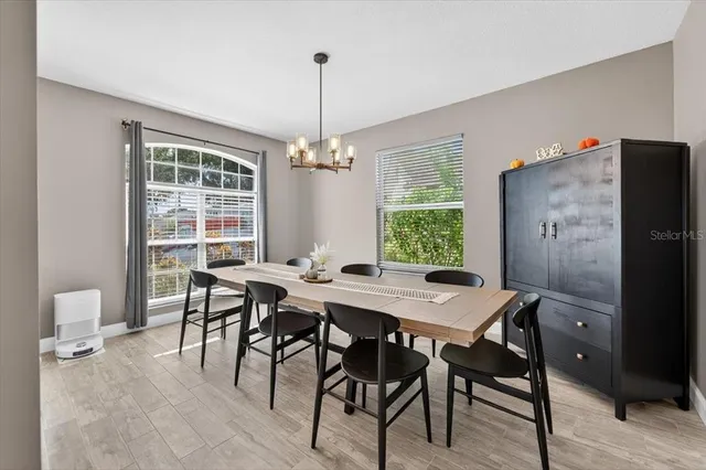 a living room with furniture a ceiling fan and a window
