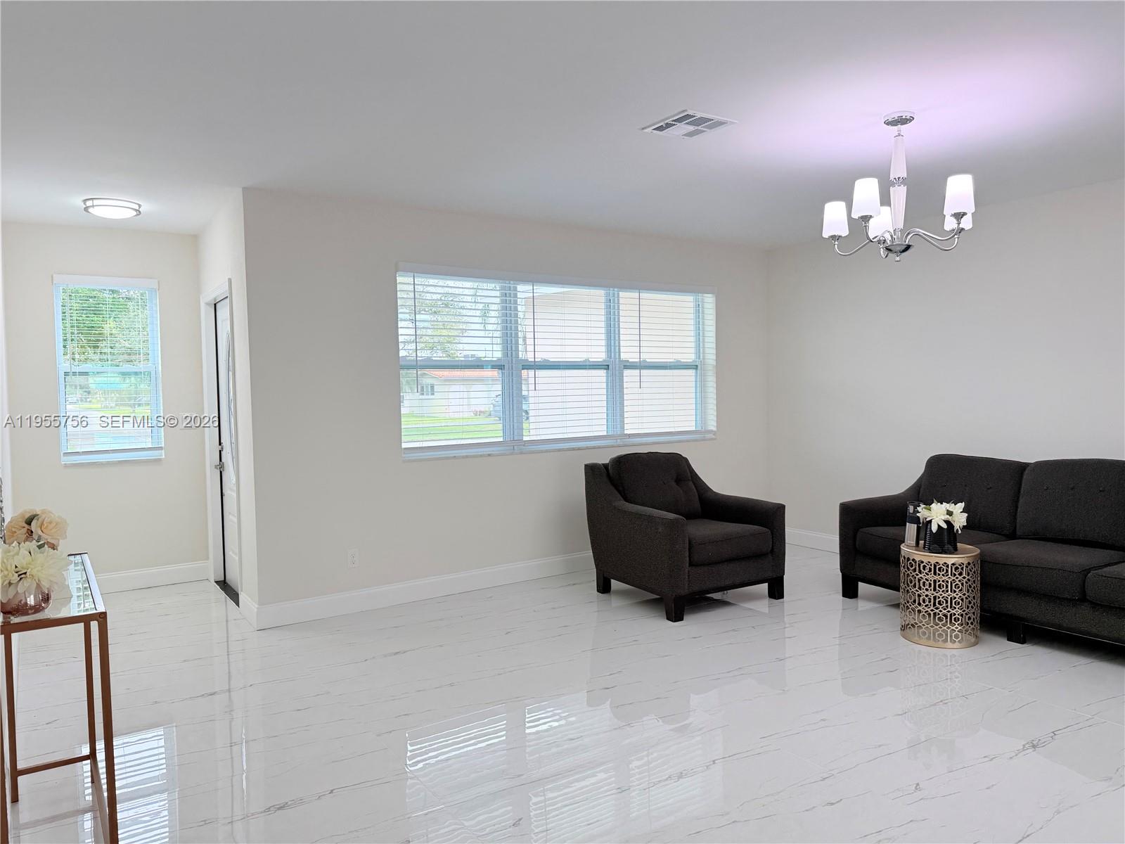 4241 Thomas Street Hollywood, FL 33021 - Photo 12 of 91 a living room with furniture chandelier and a window