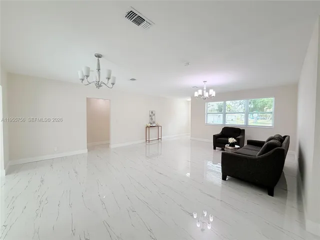 a view of living room with furniture and wooden floor