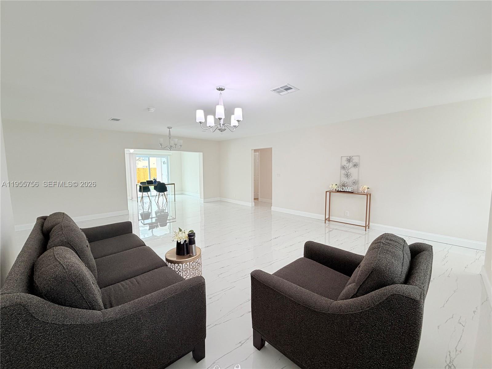 4241 Thomas Street Hollywood, FL 33021 - Photo 16 of 91 a living room with furniture a lamp and a chandelier