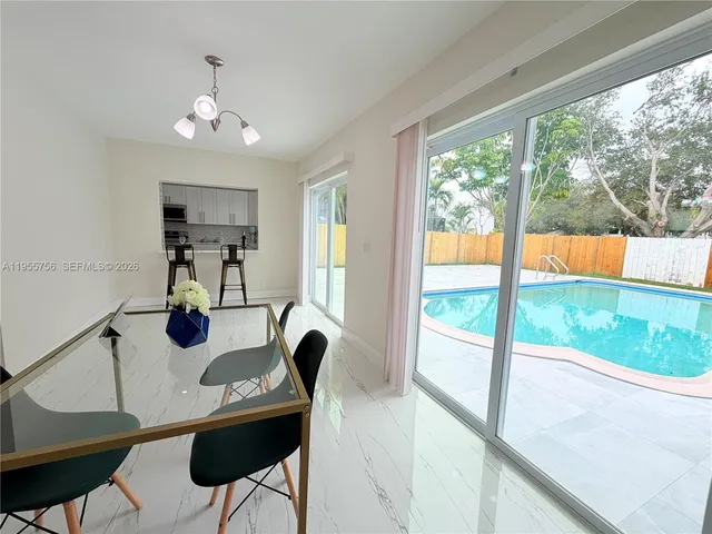a kitchen with stainless steel appliances white cabinets and a refrigerator