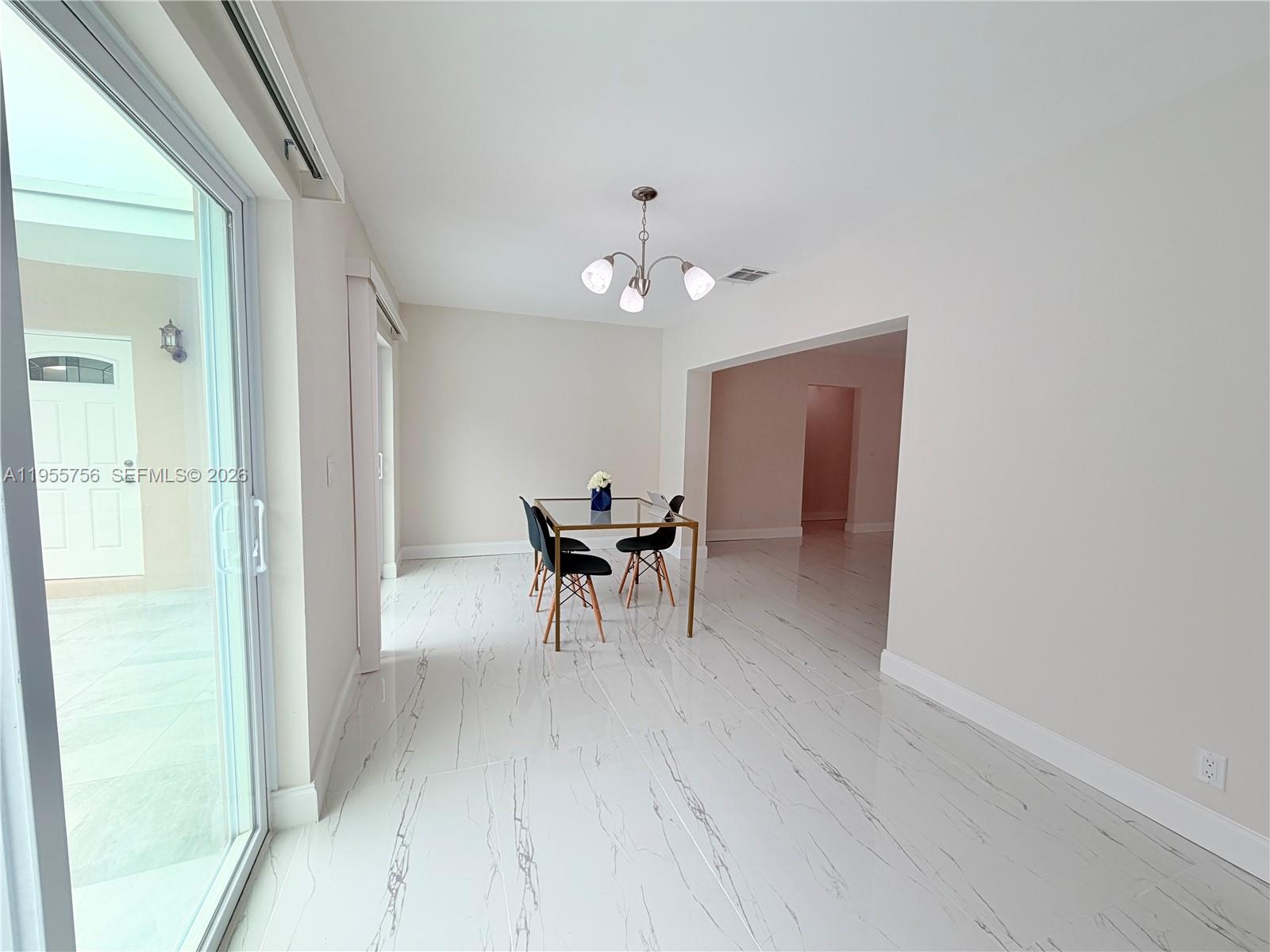 4241 Thomas Street Hollywood, FL 33021 - Photo 24 of 91 a view of a dining room with furniture and a chandelier