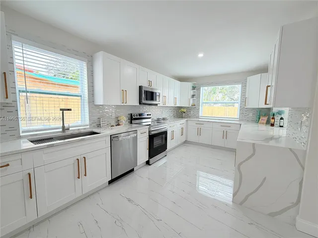 a view of a room with wooden floor and a ceiling fan