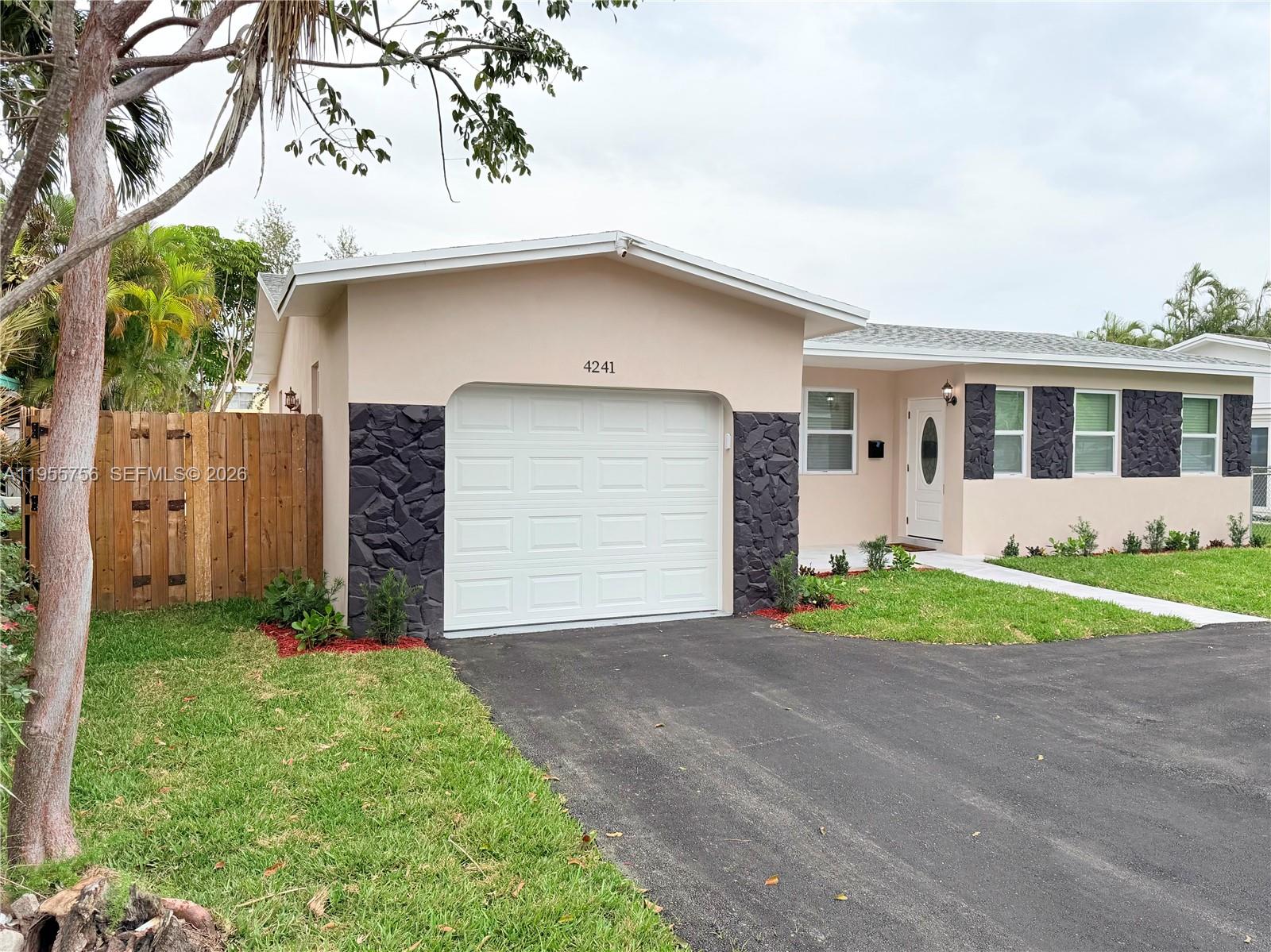 4241 Thomas Street Hollywood, FL 33021 - Photo 3 of 91 a front view of a house with a yard and garage