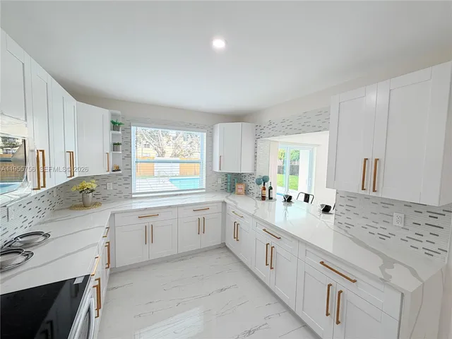 a view of a room with wooden floor and a window