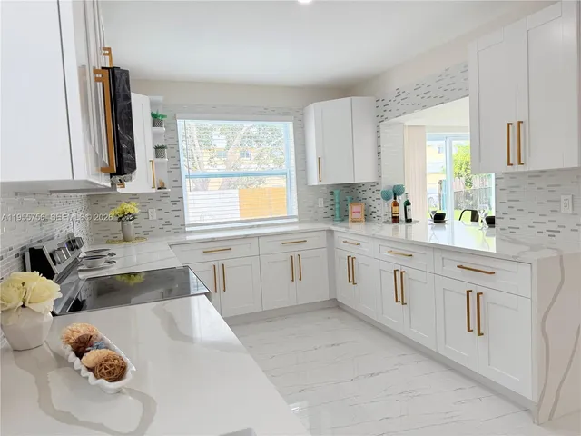a view of empty room with wooden floor and window