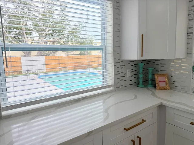 a view of a room with a wooden floor and a ceiling fan