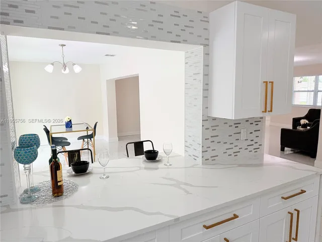 a view of a room with wooden floor and a window