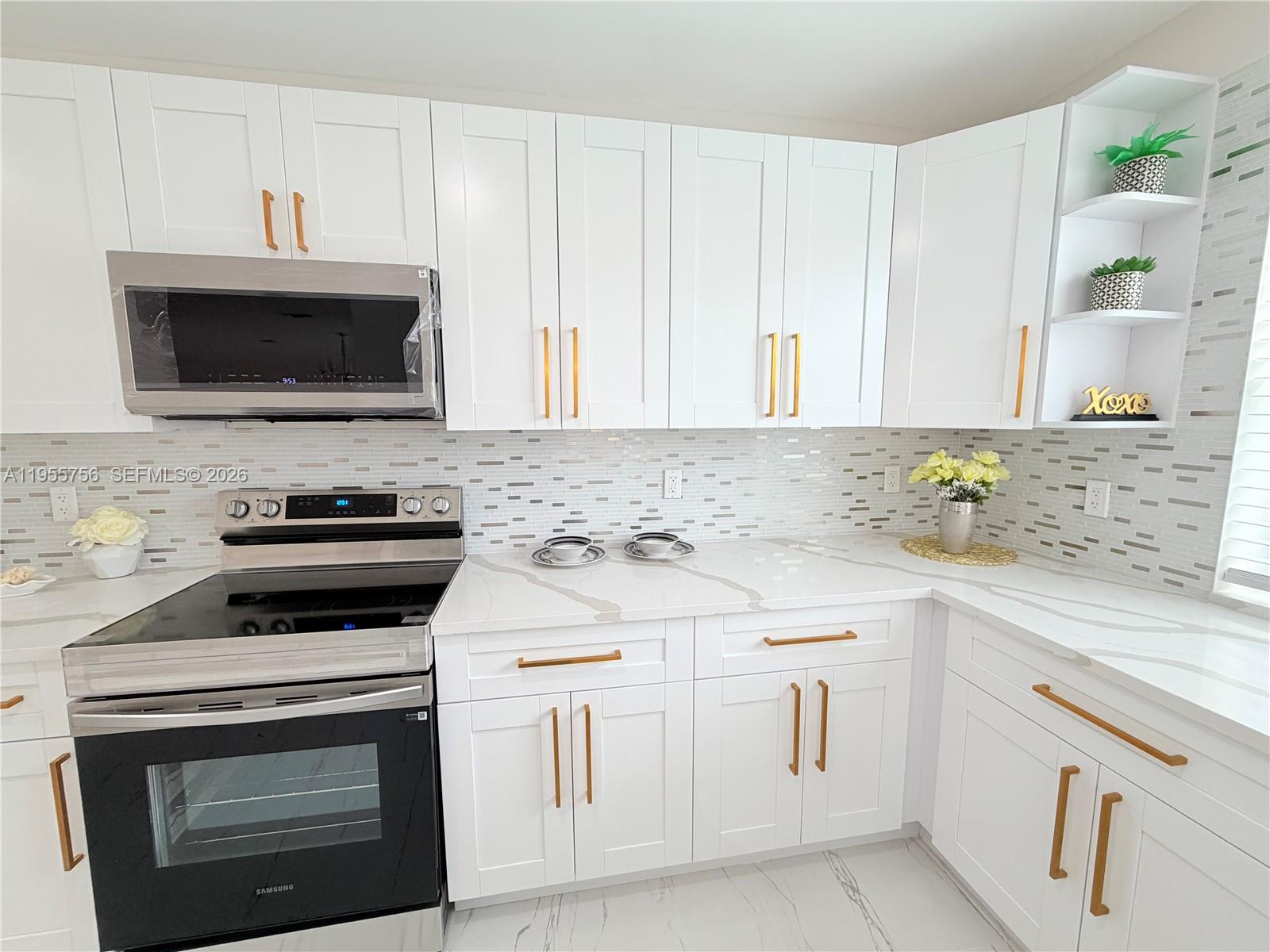 4241 Thomas Street Hollywood, FL 33021 - Photo 40 of 91 a kitchen with white cabinets and stainless steel appliances