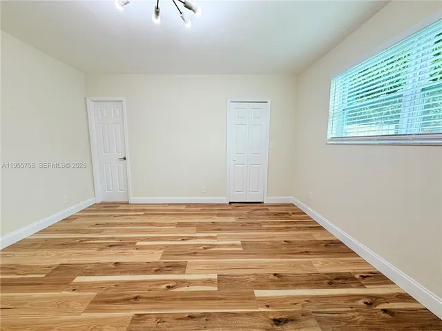 a view of backyard with swimming pool and seating space