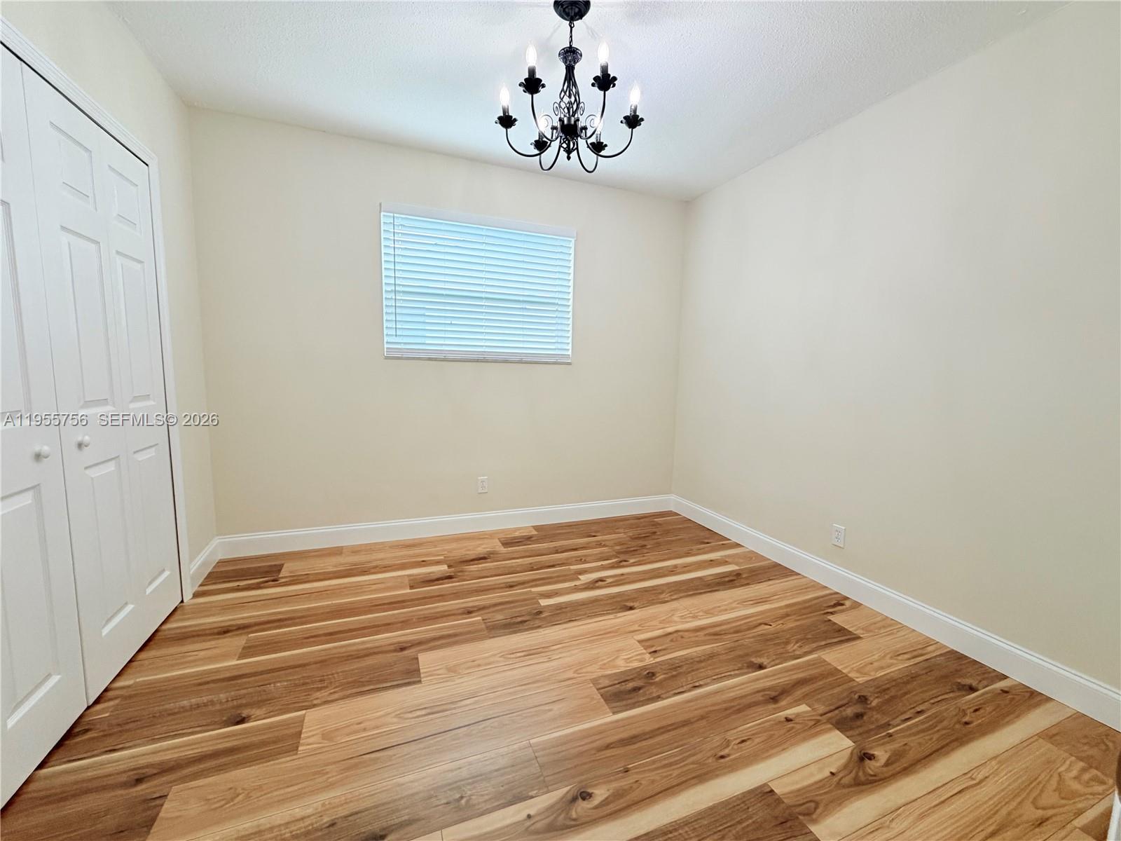 4241 Thomas Street Hollywood, FL 33021 - Photo 51 of 91 a view of a chandelier fan and wooden floor