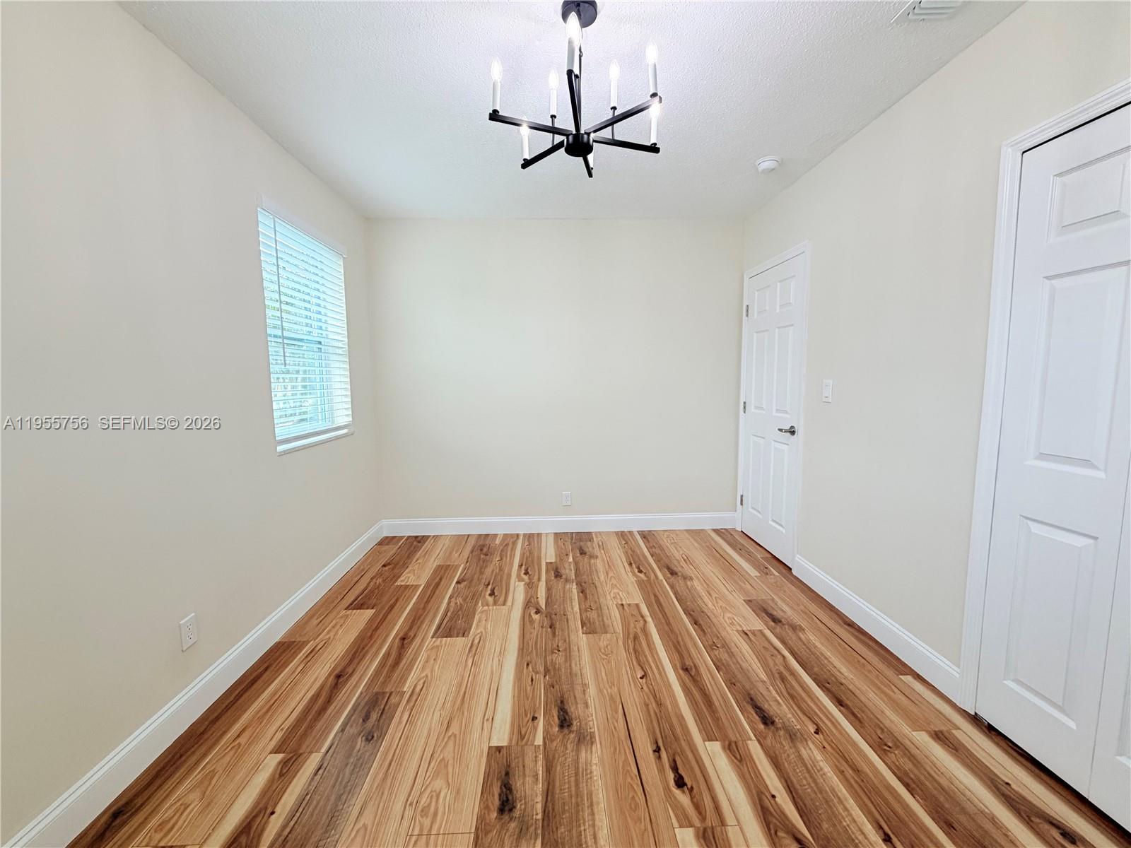 4241 Thomas Street Hollywood, FL 33021 - Photo 58 of 91 a view of a room with a wooden floor and a ceiling fan
