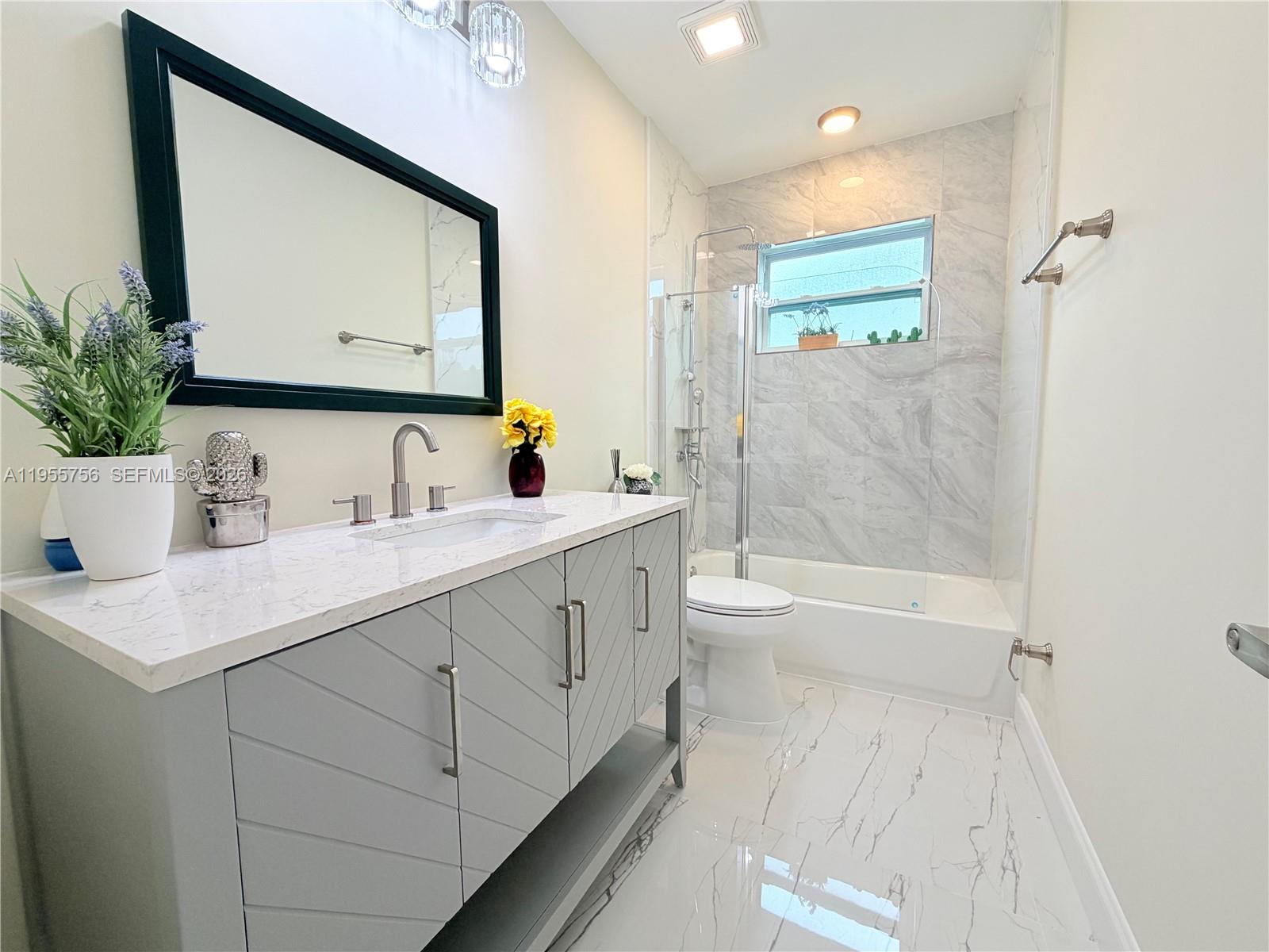 4241 Thomas Street Hollywood, FL 33021 - Photo 61 of 91 a bathroom with a sink a toilet a mirror and shower