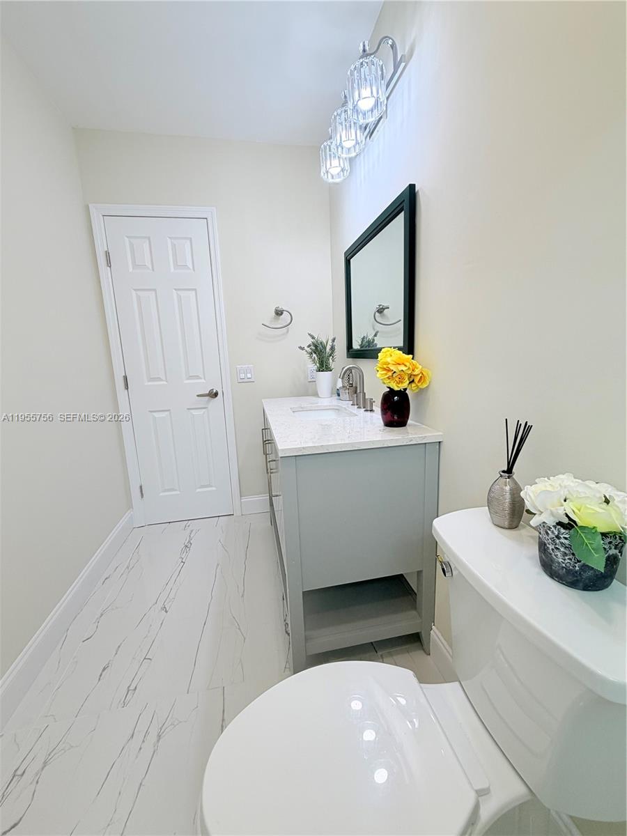 4241 Thomas Street Hollywood, FL 33021 - Photo 62 of 91 a bathroom with a sink a mirror and vanity
