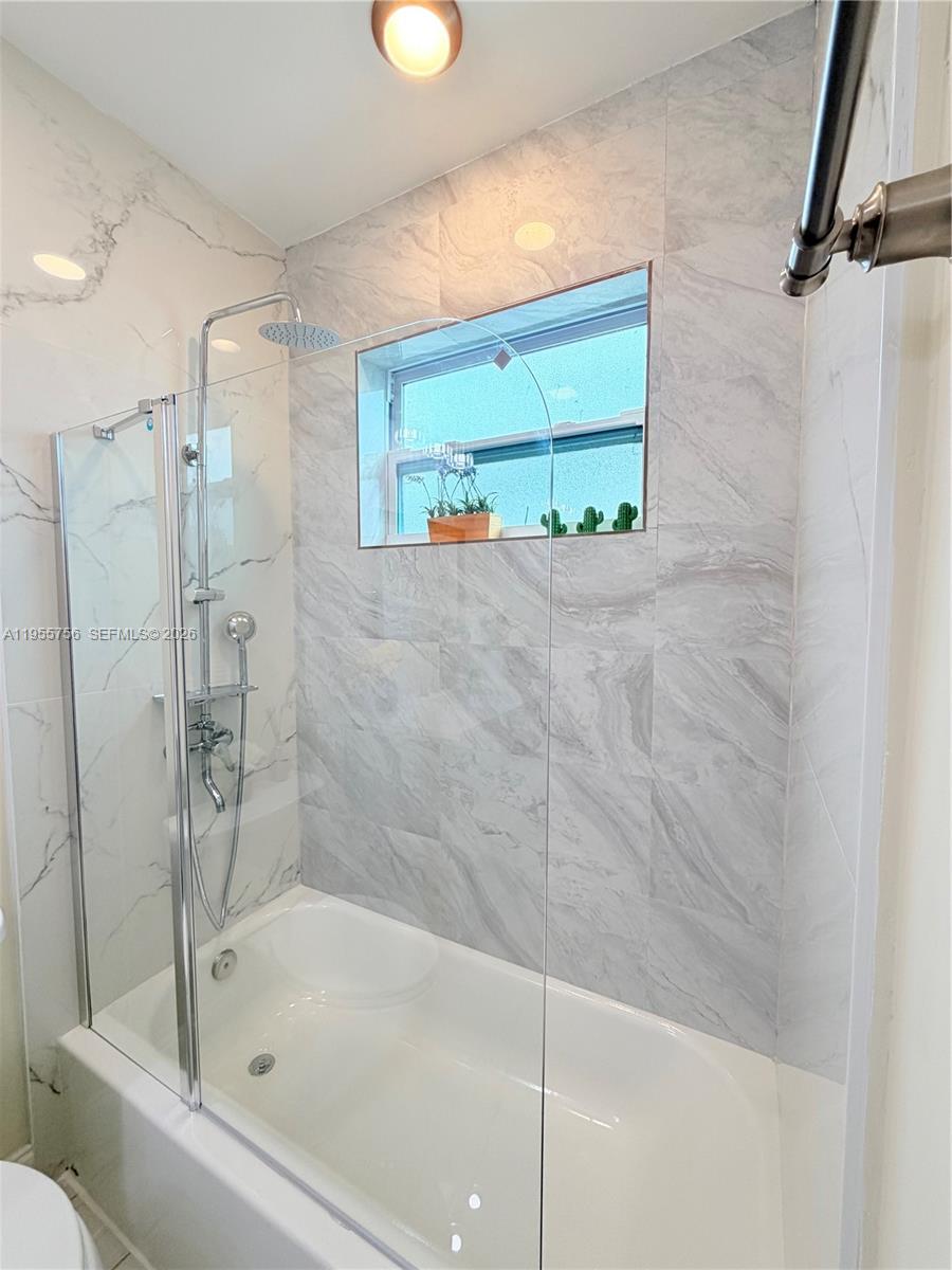 4241 Thomas Street Hollywood, FL 33021 - Photo 63 of 91 a bathroom with a tub and shower