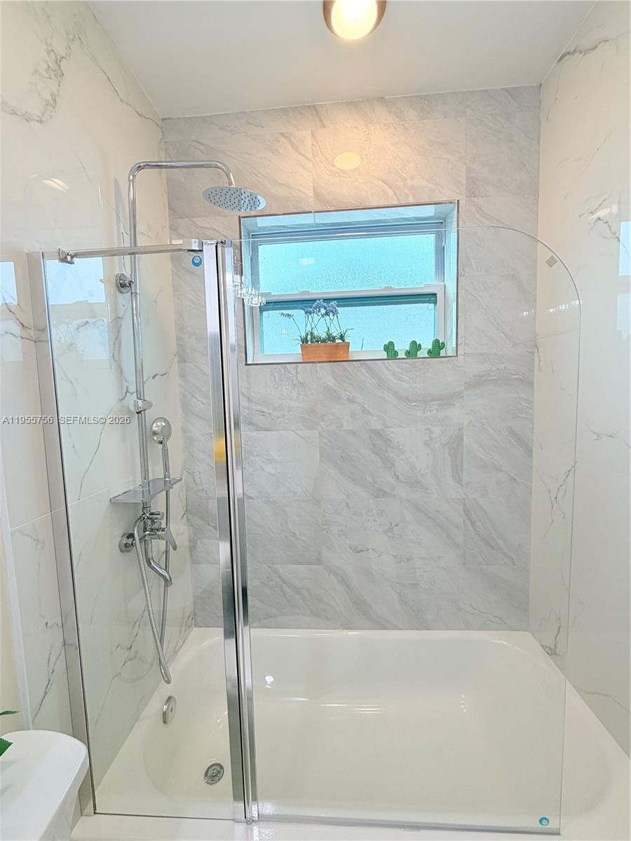 4241 Thomas Street Hollywood, FL 33021 - Photo 64 of 91 a bathroom with a shower and a toilet