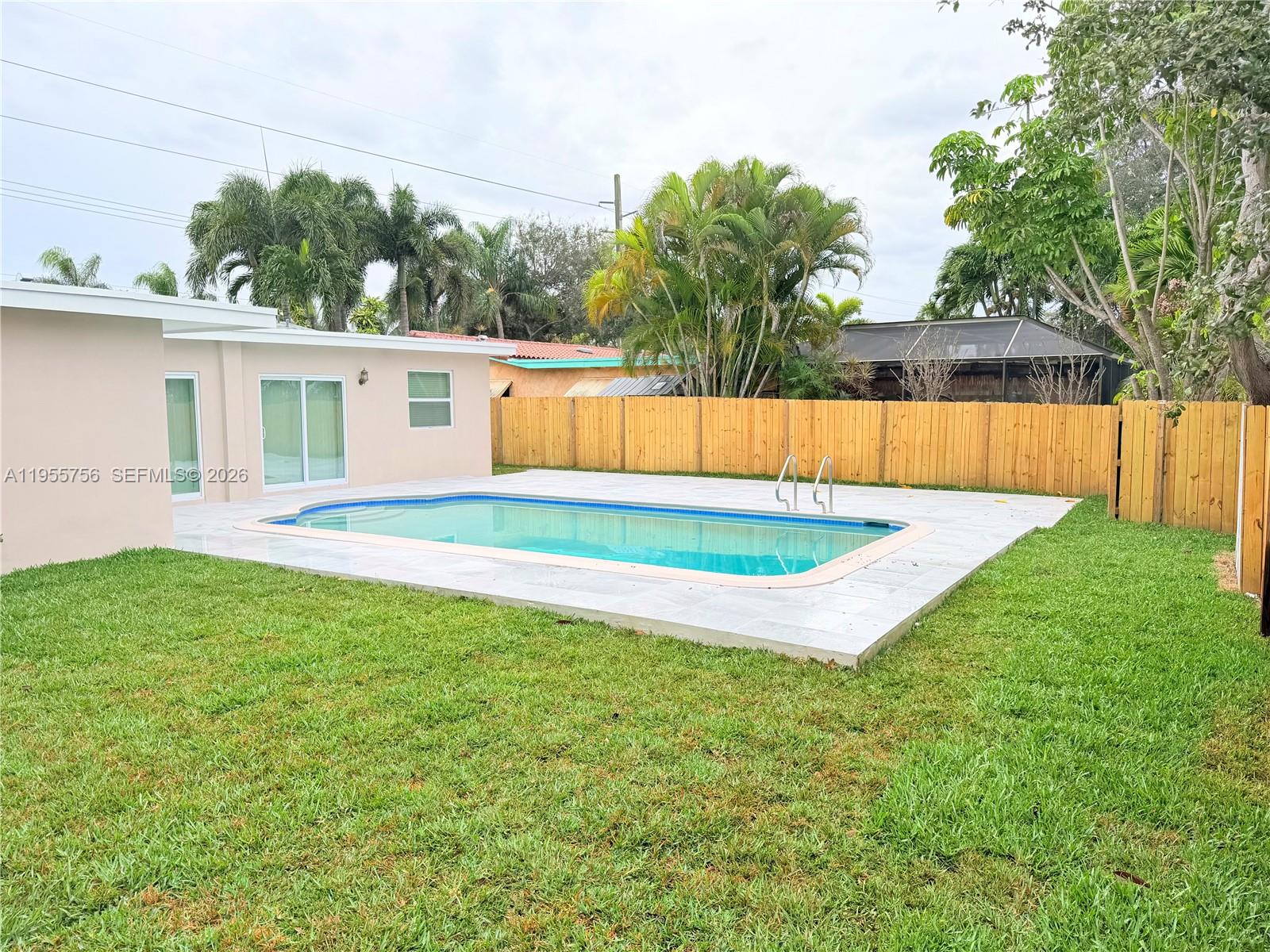 4241 Thomas Street Hollywood, FL 33021 - Photo 69 of 91 a view of backyard with swimming pool and seating space