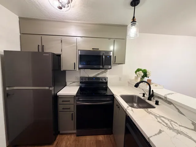 a kitchen with a refrigerator and a sink