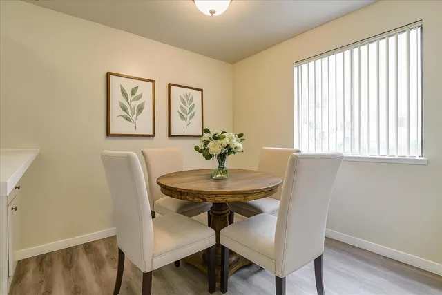 a dining room with furniture and window