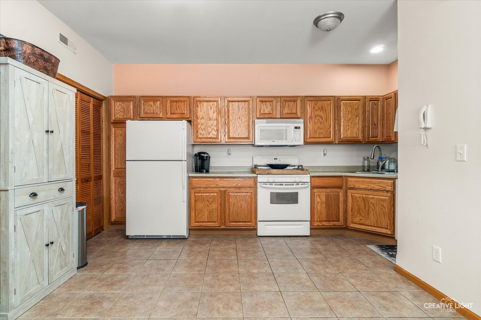 575 North Strack Street, Unit 103 Cortland, IL 60112 - Photo 3 of 11 a kitchen with white cabinets and white appliances