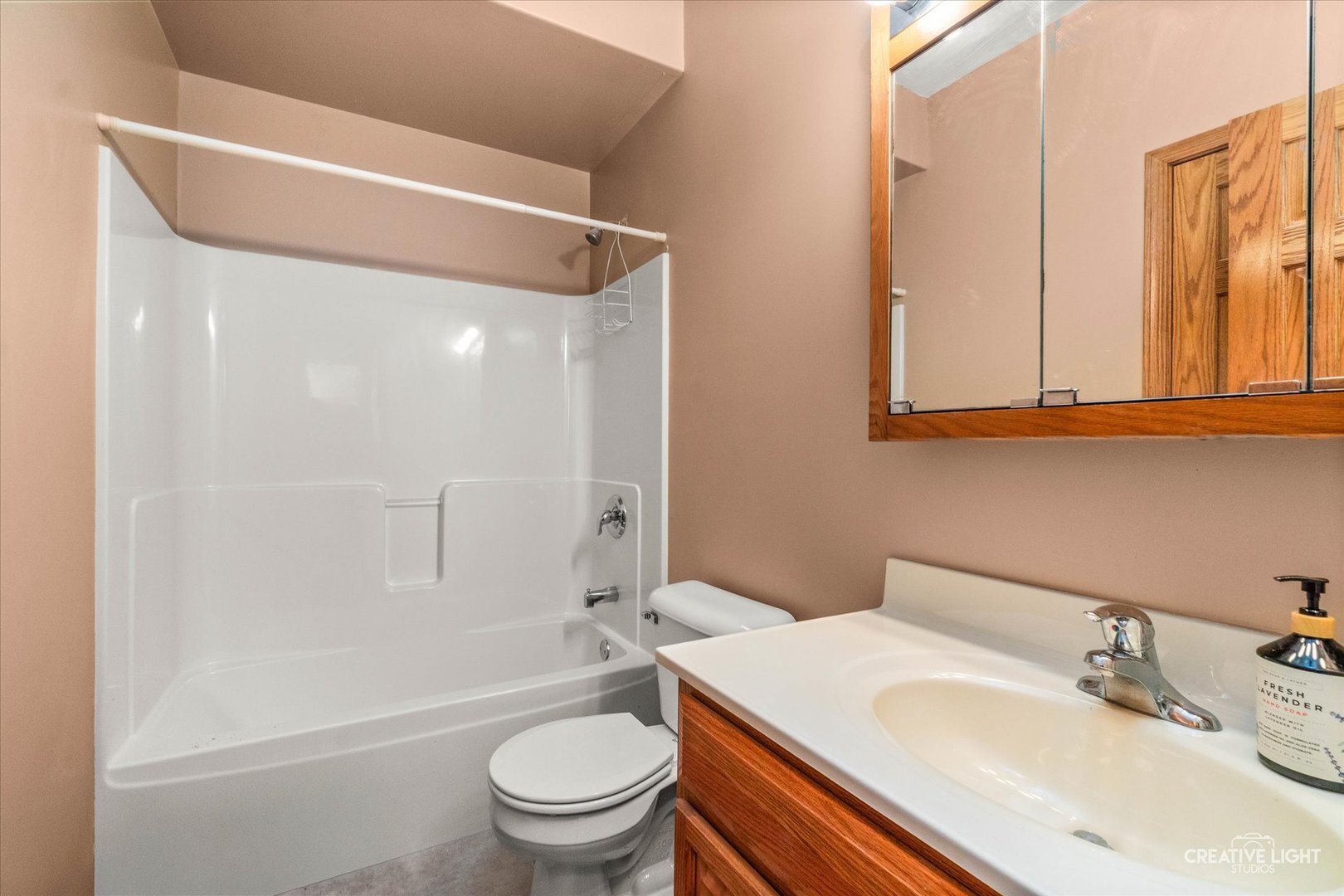 575 North Strack Street, Unit 103 Cortland, IL 60112 - Photo 6 of 11 a bathroom with a sink toilet and shower