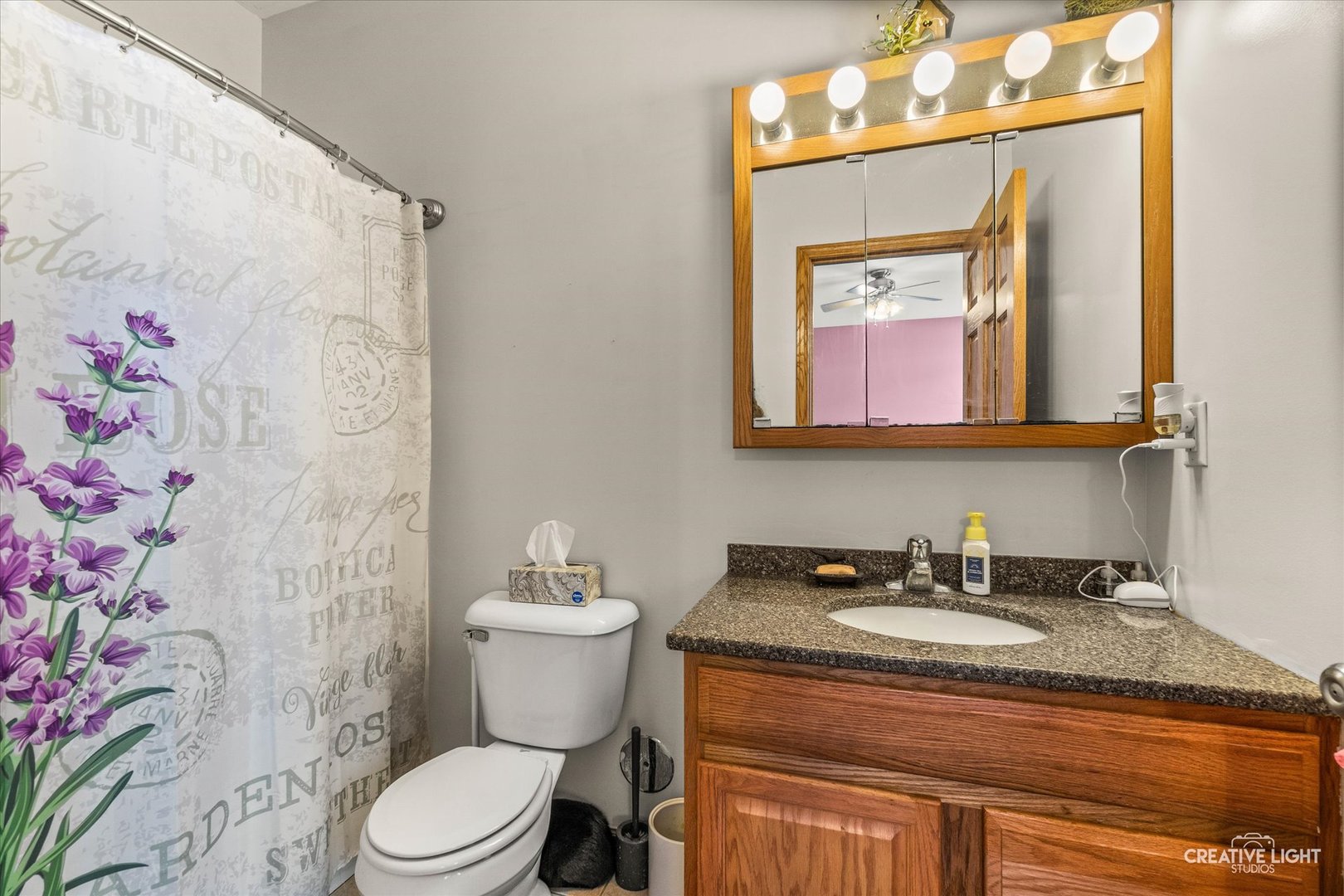 575 North Strack Street, Unit 103 Cortland, IL 60112 - Photo 8 of 11 a bathroom with a toilet sink and mirror