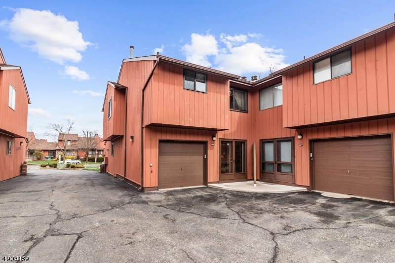 250 Ridgedale Avenue, Unit B 8 Florham Park, NJ 07932 - Photo 1 of 20 a front view of a house with basket ball court and a garage