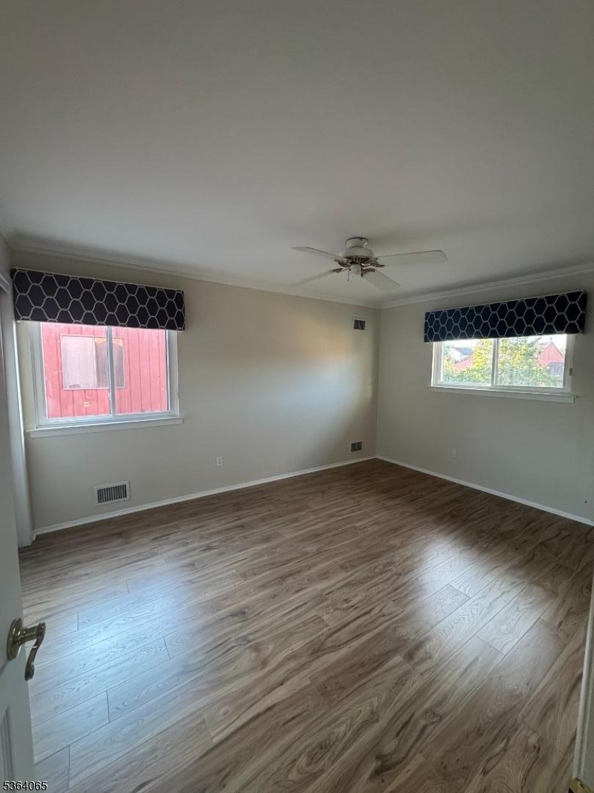 250 Ridgedale Avenue, Unit B 8 Florham Park, NJ 07932 - Photo 11 of 20 an empty room with wooden floor and windows