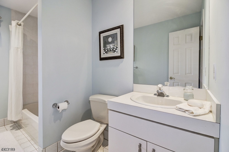 250 Ridgedale Avenue, Unit B 8 Florham Park, NJ 07932 - Photo 11 of 19 a bathroom with a toilet a sink and mirror
