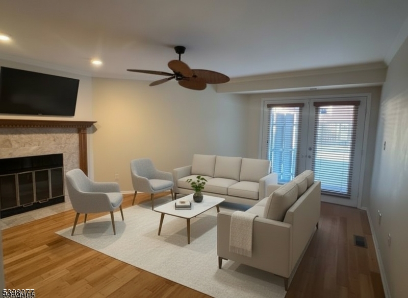 250 Ridgedale Avenue, Unit B 8 Florham Park, NJ 07932 - Photo 7 of 19 a living room with furniture a flat screen tv and a fireplace