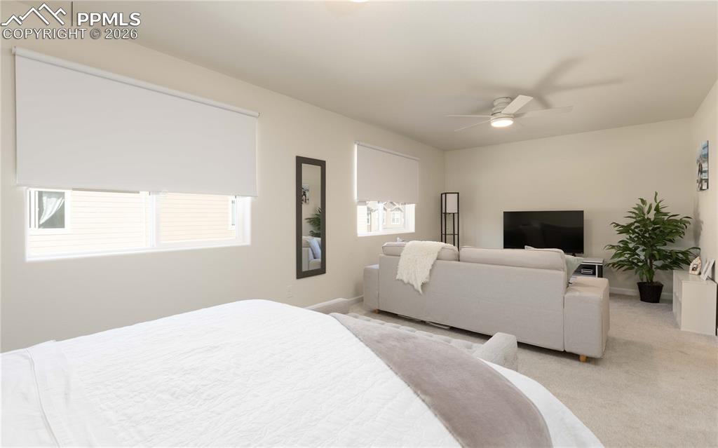 4031 Samaritan Loop Colorado Springs, CO 80916 - Photo 11 of 34 a bedroom with a white bed and a couch