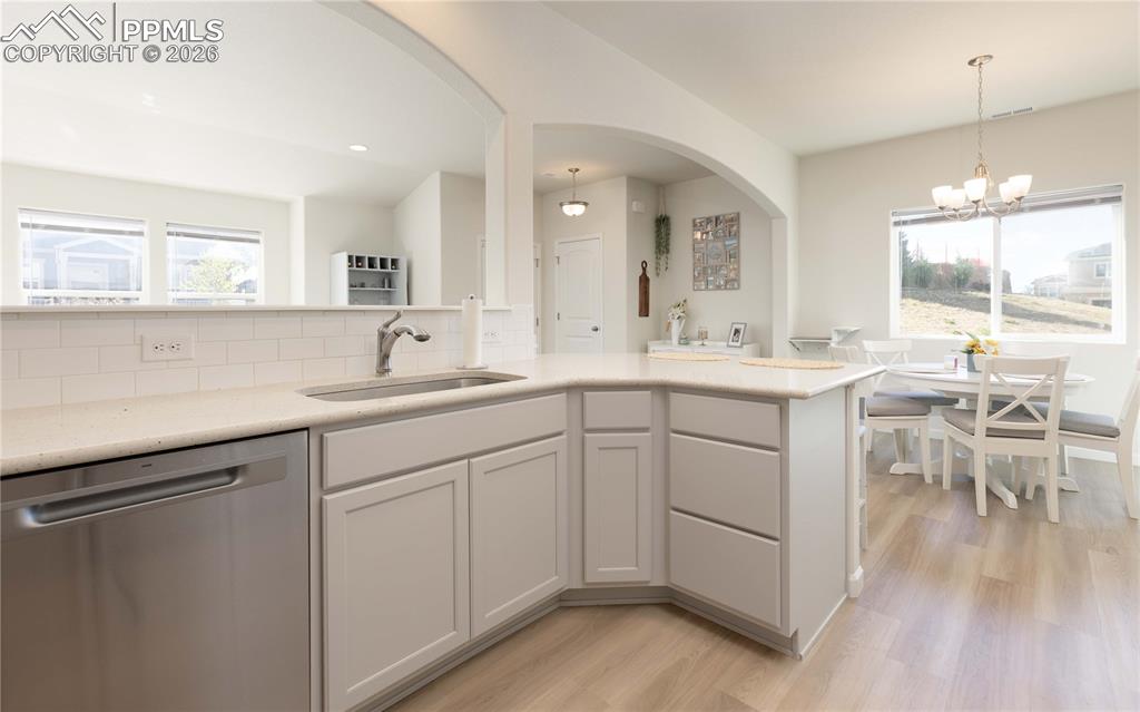 4031 Samaritan Loop Colorado Springs, CO 80916 - Photo 6 of 34 a kitchen with a sink cabinets and dining table