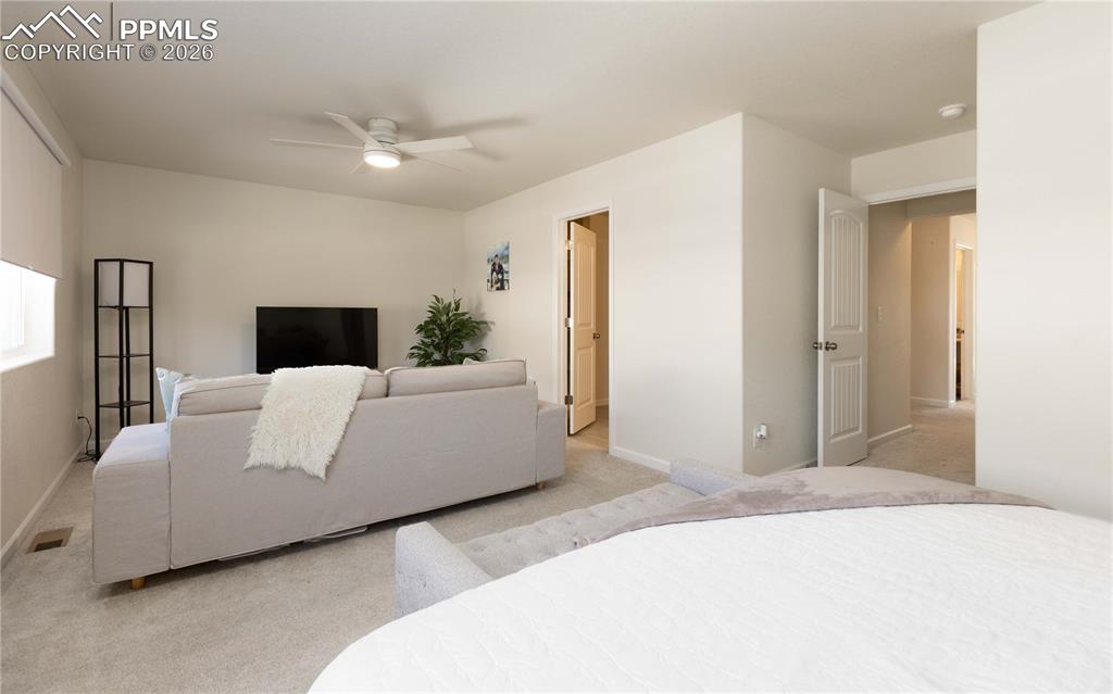 4031 Samaritan Loop Colorado Springs, CO 80916 - Photo 10 of 34 a living room with a couch and a dresser
