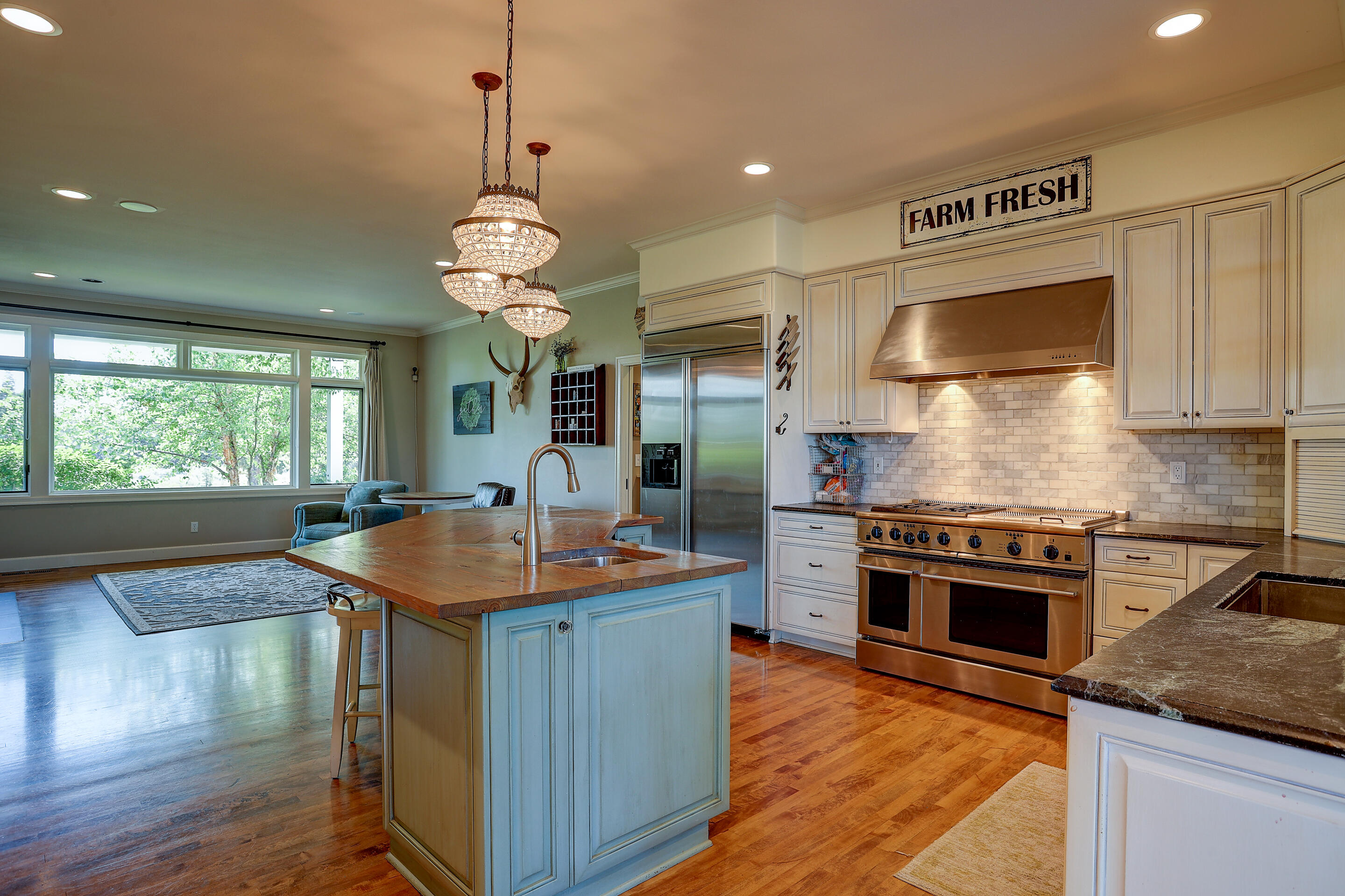 61415 Gosney Road Bend, OR 97702 - Photo 8 of 47 a kitchen with stainless steel appliances granite countertop a sink stove and refrigerator