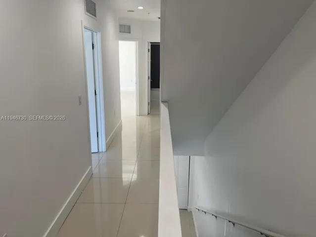 a kitchen with stainless steel appliances a sink a stove a microwave a refrigerator and cabinets