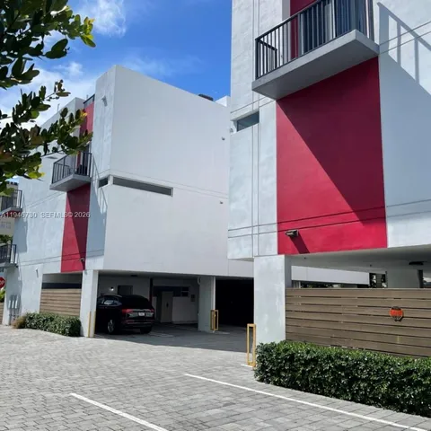 a front view of a house with plants