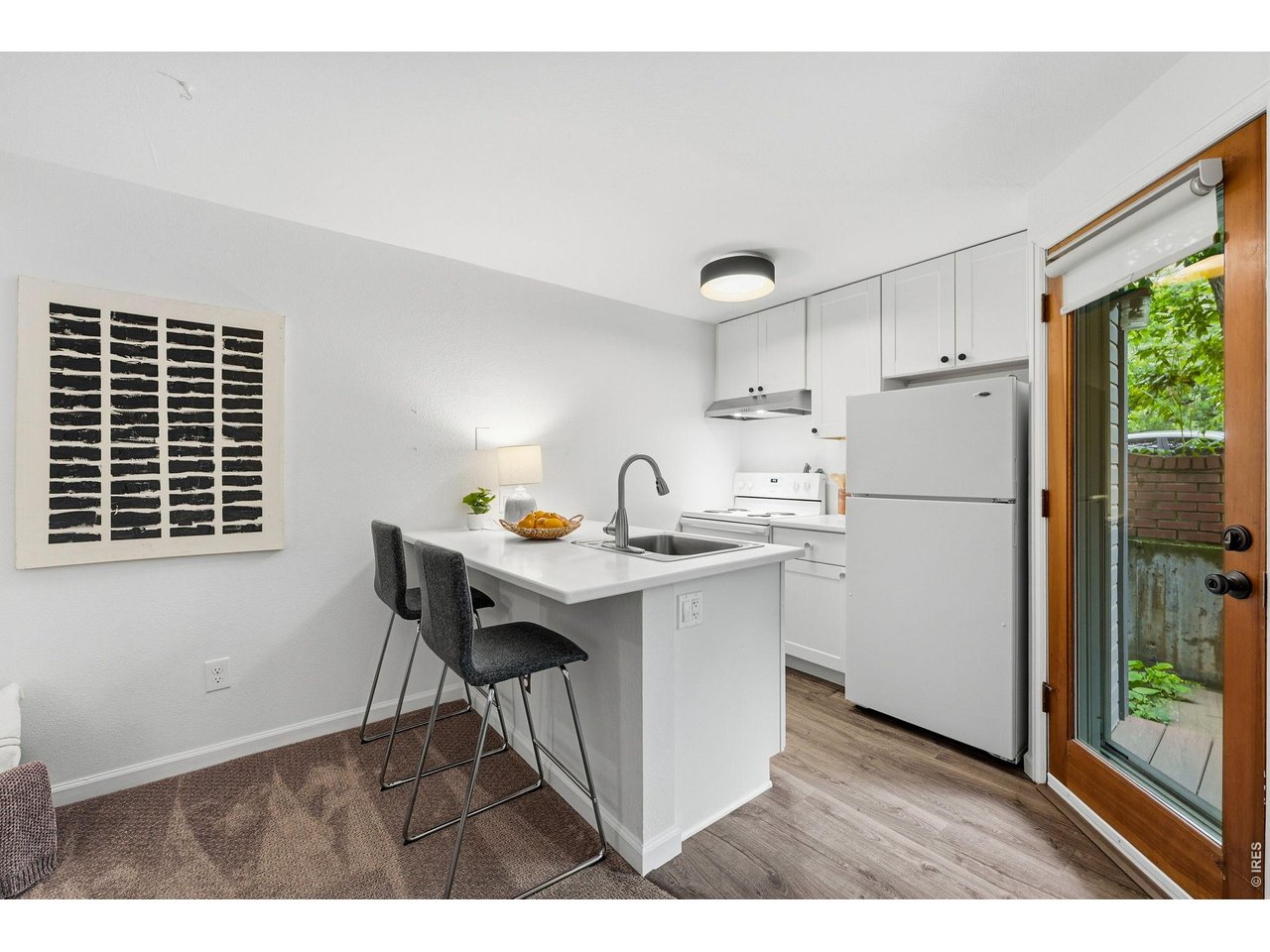 910 Portland Place, Unit 2 Boulder, CO 80304 - Photo 5 of 18 a kitchen with refrigerator cabinets and wooden floor