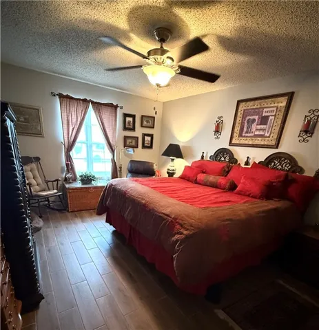a bedroom with a bed mirror and window