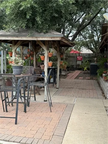 a view of a chairs and tables in patio