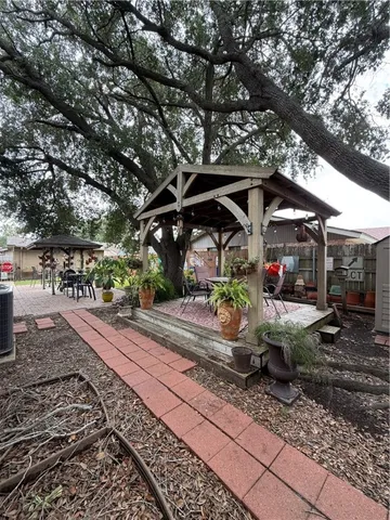 a view of a table and chairs under an umbrella